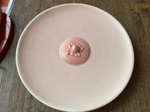 Pink body-themed ceramic plate used at Naked Soho restaurant.