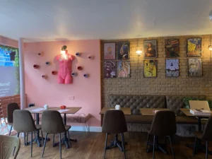 Colourful dining room and provocative artwork inside Naked Soho restaurant.