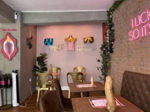 Colourful dining room and provocative artwork inside Naked Soho restaurant.