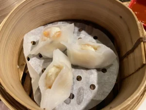 Steamed dumplings served in a bamboo basket at Leong’s Legend London.