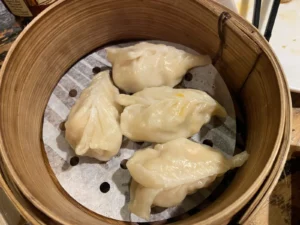 Steamed dumplings served in a bamboo basket at Leong’s Legend London.