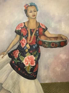 Portrait of Frida Kahlo in a floral dress displayed at Tate Modern
