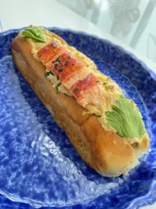 Harrods lobster roll served on a blue plate