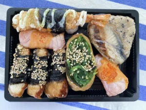 Fresh nigiri and inari in a Sushi Joy takeaway box