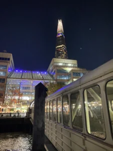 The Shard illuminated at night from the Uber Boat on the Thames